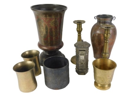 A group of metal wares, comprising a pair of brass candlesticks, brass mortars, a pewter money box, eastern red enamel vase, 30cm high, etc.