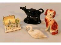 A 19thC Staffordshire pottery spaniel with separate front leg