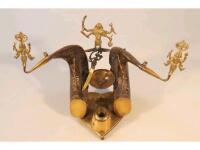 A Indian cast brass desk stand mounted with buffalo horns and with Hindu deiti terminals