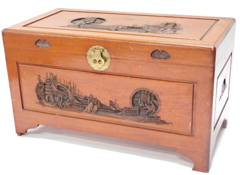 An oriental camphorwood chest, with carved sides and brass lock etc, 57cm high, 100cm wide, 52cm deep.