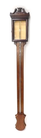 A 20thC mahogany stick barometer, with paper dial, visible tube and shield shaped cistern cover, 100cm high.