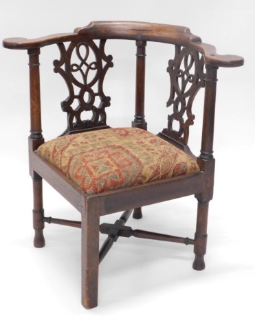 A 19thC oak corner chair, with carved back, and upholstered seat, on X frame base, 75cm high.