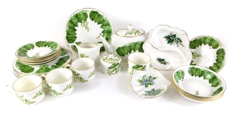 A Royal Crown Duchy tea and dinner service, in the Ivy Blossom Ladybird pattern, comprising teapot, milk jug, sugar bowl, four teacups, shell capped bowl, four breakfast bowls, eight side plates, eight dinner plates.