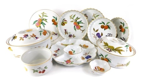 A Royal Worcester Evesham pattern part service, comprising large oval tureen and cover, 31cm wide, small oval tureen and cover, 24cm wide, graduated set of four flan dishes, a cake plate, hors d'oeuvres dish, ramekin, 17.5cm wide, and a shell scallop dish