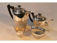 A silver plated four piece tea service with half fluted bodies comprising tea pot