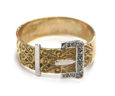 A 9ct gold buckle ring, white and yellow gold, with scroll detail and tiny diamond set, ring size X½, 4.4g all in.