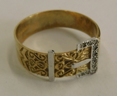 A 9ct gold buckle ring, white and yellow gold, with scroll detail and tiny diamond set, ring size X½, 4.4g all in. - 2