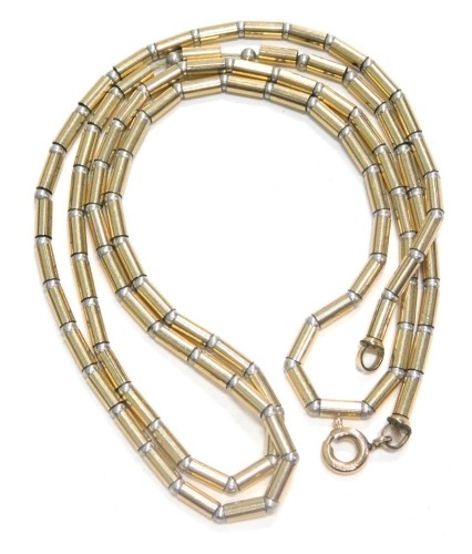 A 9ct gold and silver necklace, of modern form, on string strand, with yellow metal clasp stamped 375, 56cm long, 7.5g all in.