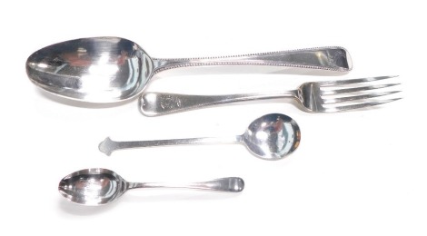 A group of silver cutlery, comprising a fiddle pattern beaded serving spoon, with dove crest, maker TC, London 1856, two silver teaspoons, and silver fiddle pattern starter fork, inscribed HJ, 4.22oz. (4)