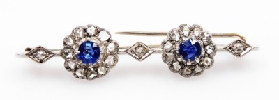 An Edwardian sapphire and diamond bar brooch, set with two rose cut sapphires, in a circular surround of diamonds, interspersed with diamonds in a lozenge setting, in white metal, 6.2g all in. - 3