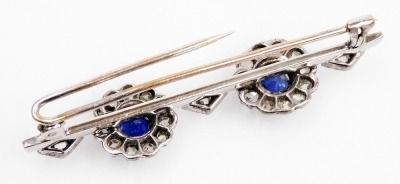 An Edwardian sapphire and diamond bar brooch, set with two rose cut sapphires, in a circular surround of diamonds, interspersed with diamonds in a lozenge setting, in white metal, 6.2g all in. - 4