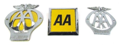 Three AA car badges.