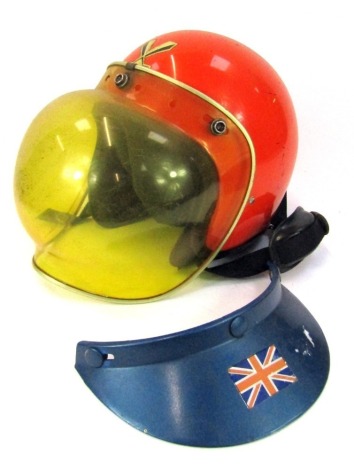 A vintage motorcycle crash helmet, with Centurion label, yellow Perspex adjustable visor with leather and foam interior.