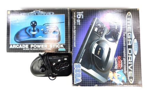 A Sega Mega Drive, boxed, together with two arcade power sticks, one boxed.