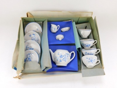 A mid century child's porcelain miniature tea service, decorated with blue flowers against a white ground, together with two Indian dolls, each with a carved wooden face and cloth bodies. - 2