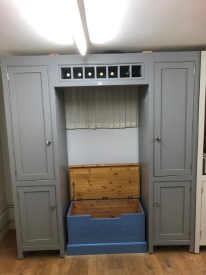 A fridge freezer surround cabinet, incorporating an overtop bottle rack. Note: VAT is payable on the hammer price of this lot at 20%.