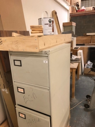 A filing cabinet, containing handles, ironmongery, fixings, Makita radio, etc., and a quantity of part finished furniture. Note: VAT is payable on the hammer price of this lot at 20%.