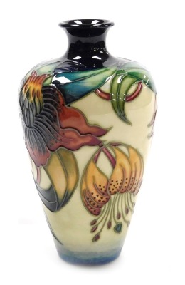 A Moorcroft pottery Anna Lily pattern vase, of shouldered tapering form, painted and impressed marks, 16cm high.