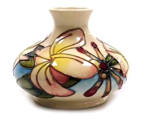 A Moorcroft pottery Frangipani pattern pottery vase, decorated on a white ground, of compressed baluster form, circa 1999, impressed and painted marks, 11cm high.