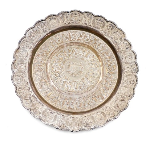 A Malaysia dish, white metal, embossed with the coat of arms of Malaysia, Island States, and foliate scrolls, 20cm wide, 3.40oz.