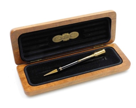 A Parker Duofold propelling pencil for Aquascutum, with black casing, in a cherrywood Aquascutum box.