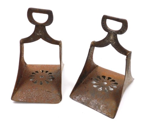 A pair of Spanish steel stirrups, with stylised flower head decoration and pierced bases. 20.5cm high.