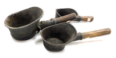 Three Chinese silk irons, with rustic wooden handles.