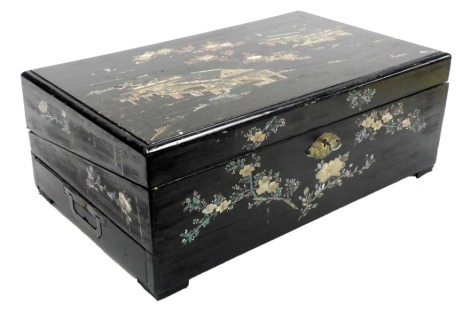 A Chinese black lacquer writing slope, decorated with mother of pearl and tortoise shell inlay in the form of buildings, flowering branches, etc., the hinged lid enclosing a green felt slope, with various recesses for pen and ink, to include a crystal blu