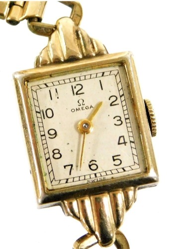 An Omega lady's 10ct gold filled wristwatch, rectangular silvered dial bearing Arabic numerals, seventeen jewelled movement, number 97211237, in a plain case, on a plated strap.