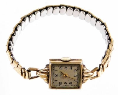 An Omega lady's 10ct gold filled wristwatch, rectangular silvered dial bearing Arabic numerals, seventeen jewelled movement, number 97211237, in a plain case, on a plated strap. - 2