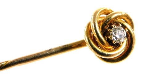 A Victorian diamond set stick pin, in a scrolling mount, yellow metal, approximately 1/16ct, boxed, 1.9g all in.