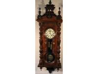 A late 19thC large mahogany cased wall clock with broken pediment and ornate