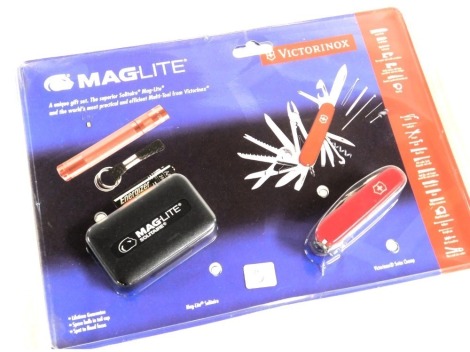 A Victorinox Swiss Army knife, together with a Mag-Lite, in a blister pack.