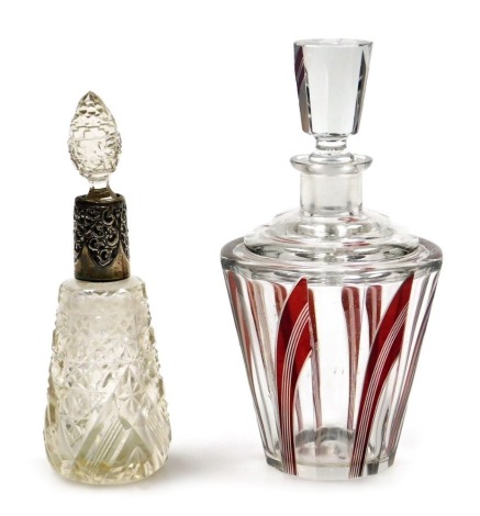 A George V cut glass and silver mounted scent bottle, with embossed C scroll decoration, London 1911, 18cm high, together with a Continental Art Deco cut glass decanter and stopper, with red geometric decoration, 21cm high. (2, AF)