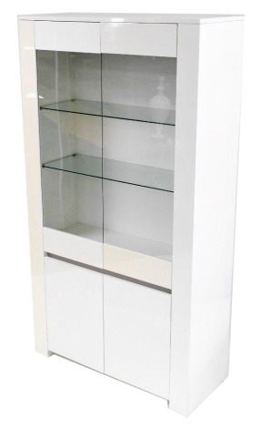 A white laminate cupboard bookcase, with two glazed doors enclosing two glass shelves, above a pair of cupboard doors, 180.5cm high, 97cm wide, 40cm deep.