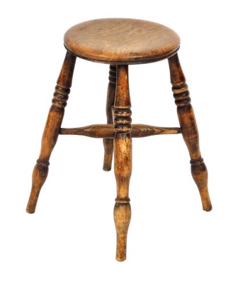 A 19thC oak stool, raised on ring turned legs united by an X frame stretcher, 52cm high.