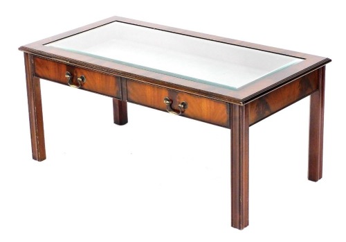 A Table Place Limited mahogany bijouterie table, with a bevelled glass top, above two dummy drawer fall flap, raised on channelled legs, 47cm high, 106cm wide, 55cm deep.