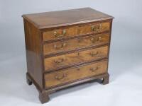 An early 19thC mahogany and rosewood cross banded chest of four graduated