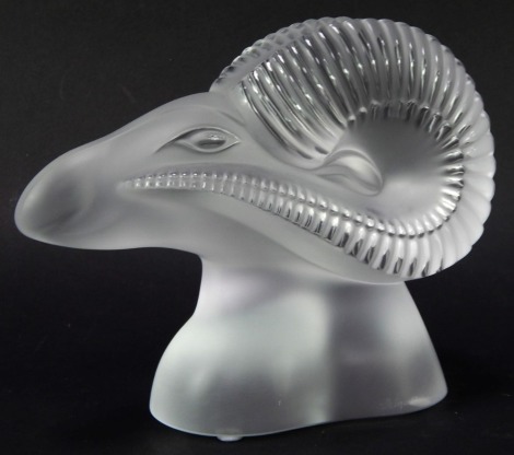 A Lalique glass paperweight, modelled as a stylised ram's head, signed Lalique France, 17cm high.