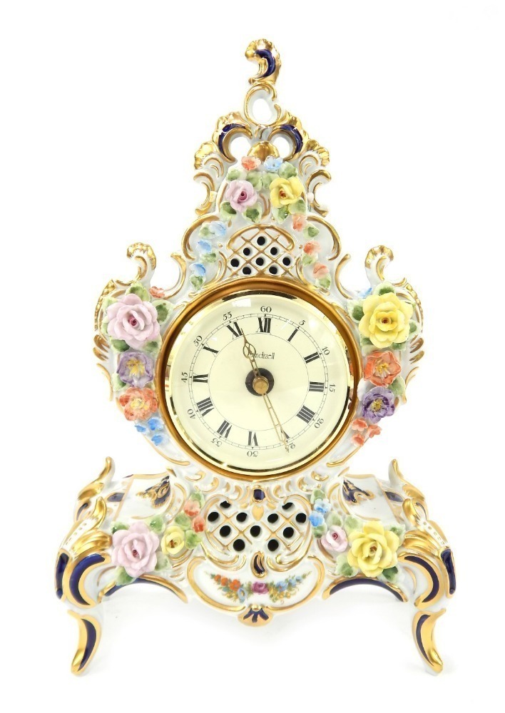 A 20thC Dresden porcelain mantel clock, the circular dial with