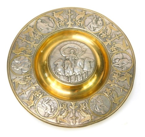 A Victorian Elkington and Co silver plated and gilt metal inkwell, of Neoclassical design, the hinged central lid decorated with an embossed study of a charioteer drawn by four horses, the outer band decorated with figures in reserves surrounded by griffi