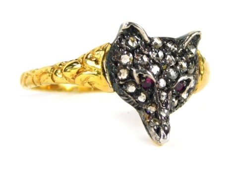 A fox dress ring, the shaped fox's head set with tiny diamonds and two ruby eyes, in white metal on a yellow metal band, unmarked, tests as 14ct, with floral design, size Q 1/2, 2g all in, boxed.