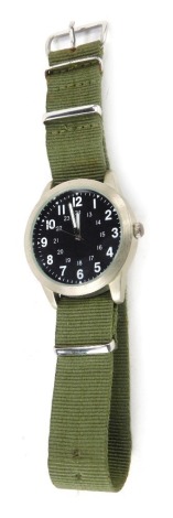 An Eagle Moss gentleman's field watch, with stainless steel casing with blackened face, with white painted numeric border, on a green khaki strap, 4cm diameter.