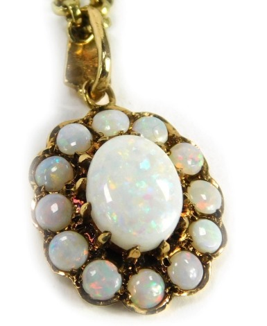 A 9ct gold opal pendant and chain, the floral design pendant set with oval opal and surrounded by twelve smaller ovals, 2cm high, on a 9ct gold curb link neck chain, 44cm long, 7.5g all in.