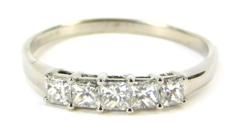 An 18ct white gold and diamond dress ring, set with five square cut diamonds, each in claw setting, totalling approximately 0.10ct, size W, 2.6g all in.