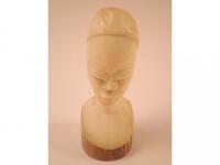 An early 20thC carved African ivory bust of a lady