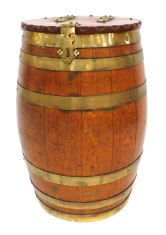 A 19thC oak and coopered barrel, the top with a hinged lid with brass mounts, enclosing a vacant interior, 57cm high.