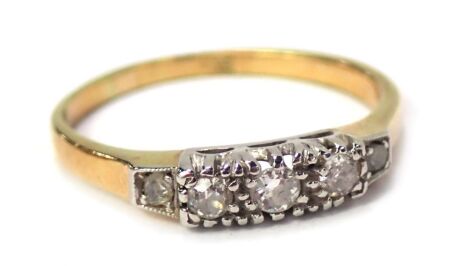 An 18ct gold diamond five stone dress ring, the five stones in platinum setting, on a yellow metal band, unmarked believed to be 18ct, ring size M, 2.4g.