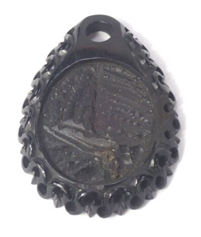 A jet carved pendant, the pendant with mountainous scene, 5cm high.