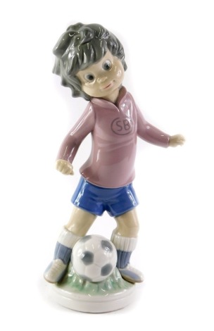 A Lladro Sport Billy Productions figure, of a child footballer, 22cm high.